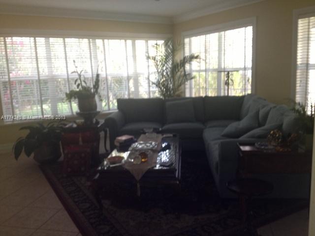 4825 Granada Boulevard Coral Gables, FL 33146 - Photo 7 of 8 a living room with furniture and a floor to ceiling window