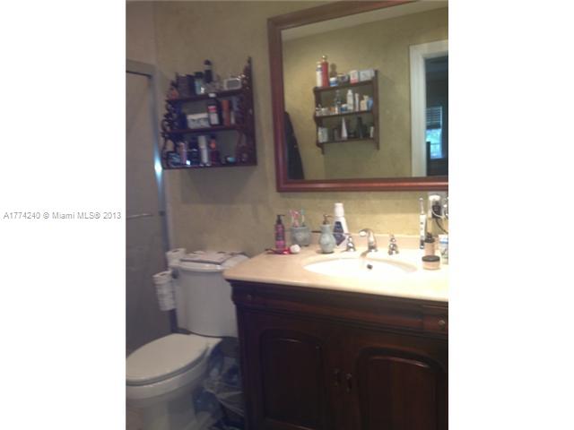 4825 Granada Boulevard Coral Gables, FL 33146 - Photo 8 of 8 a bathroom with a toilet a sink and mirror