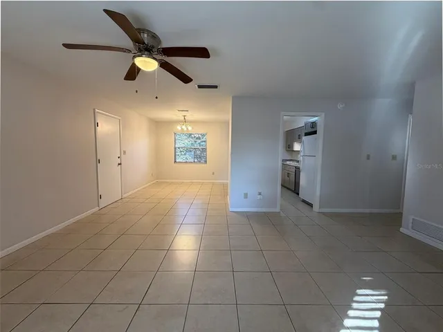 a view of an empty room and a window