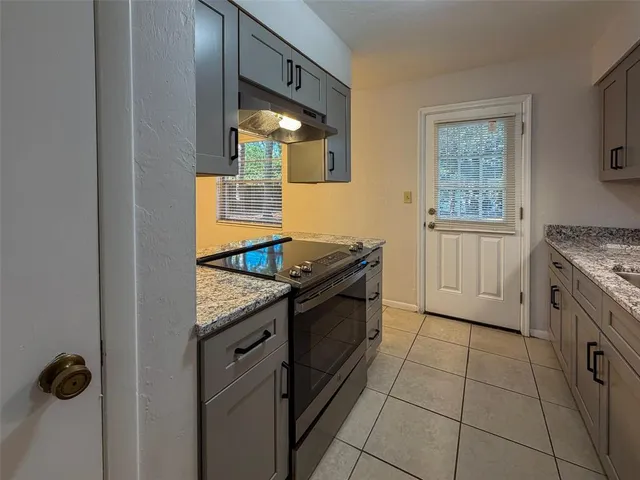 a kitchen with stainless steel appliances granite countertop a stove and a sink