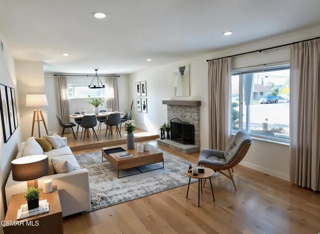 a living room with furniture fireplace and a table