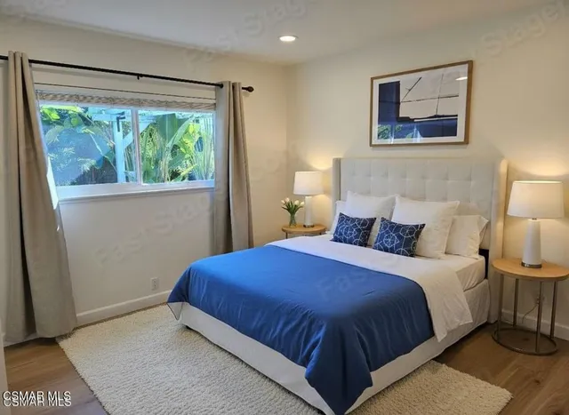 a bedroom with a large bed and a window