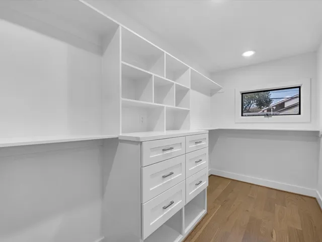a view of an empty room with a fireplace and a window