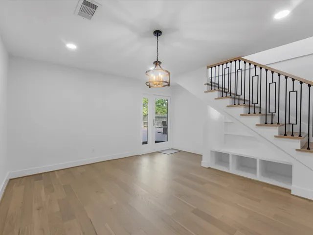 a bathroom with a double vanity sink a toilet a mirror and shower