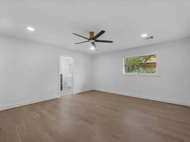 an aerial view of residential houses with outdoor space and city view