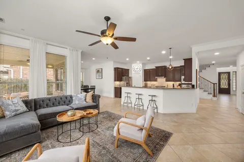 a kitchen with stainless steel appliances granite countertop wooden cabinets a stove top oven a sink and dishwasher