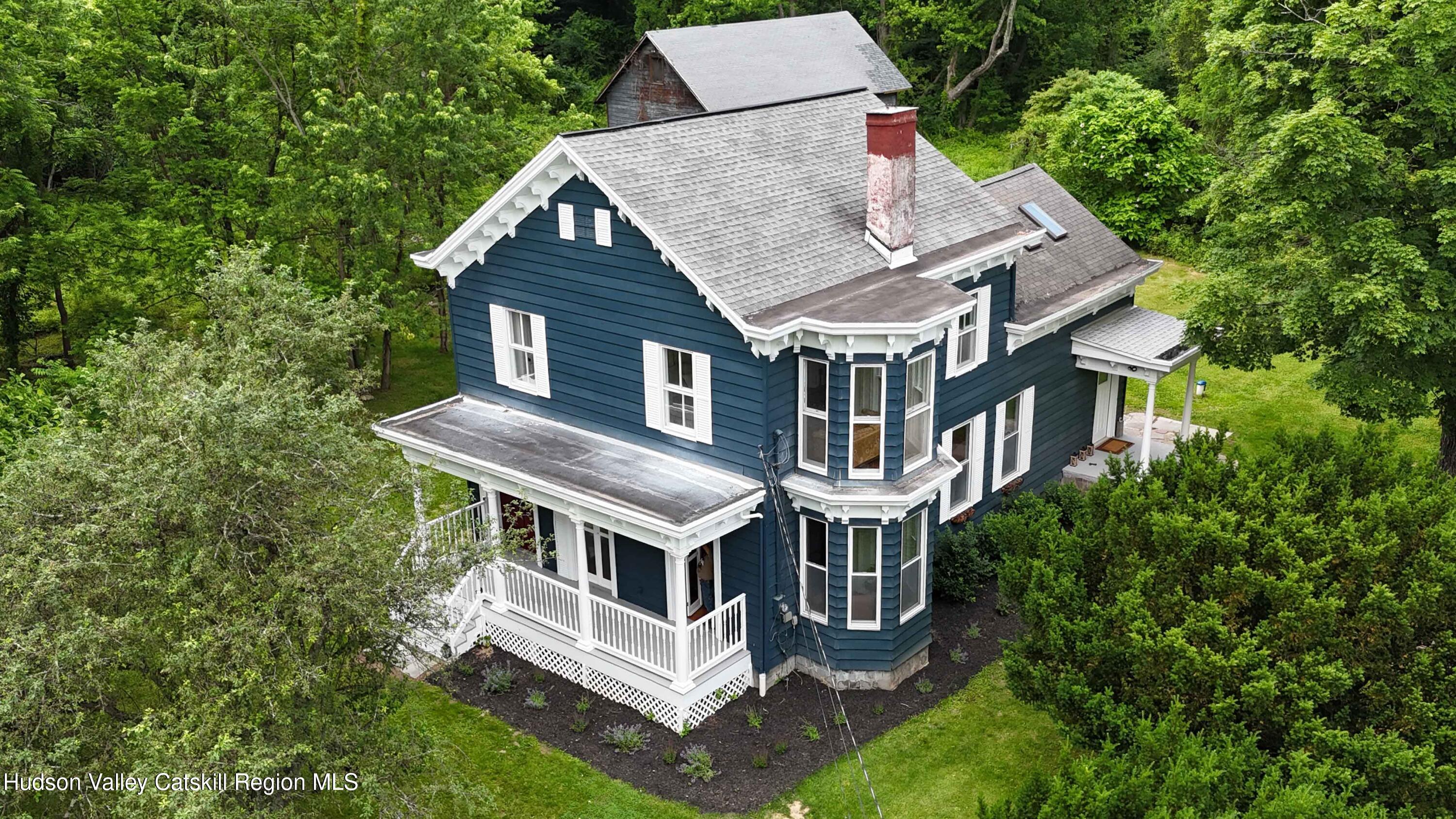 aerial view of house with a big yard and large trees