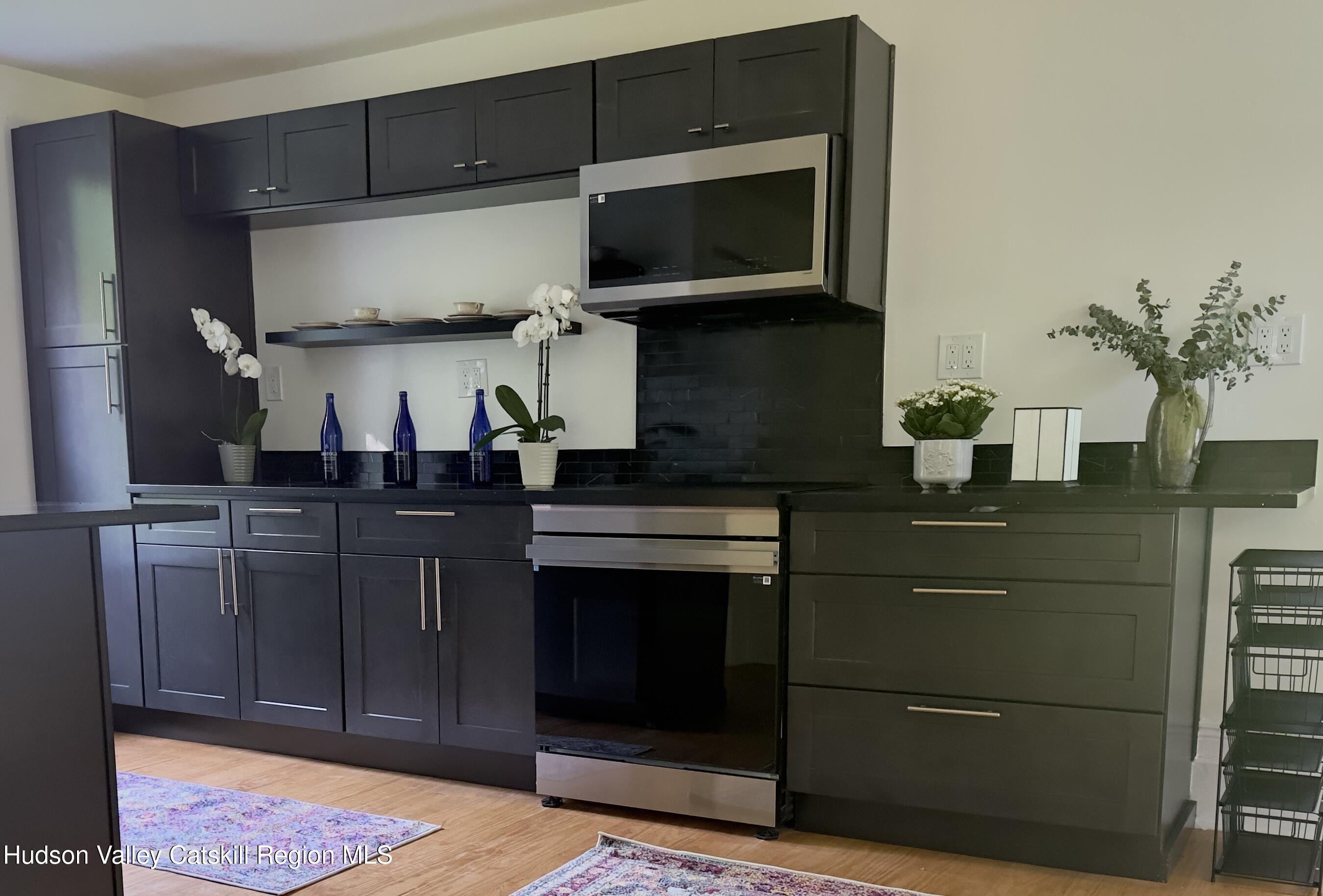 472 Lefever Falls Road Rosendale, NY 12401 - Photo 16 of 50 a kitchen with stainless steel appliances granite countertop a stove and cabinets