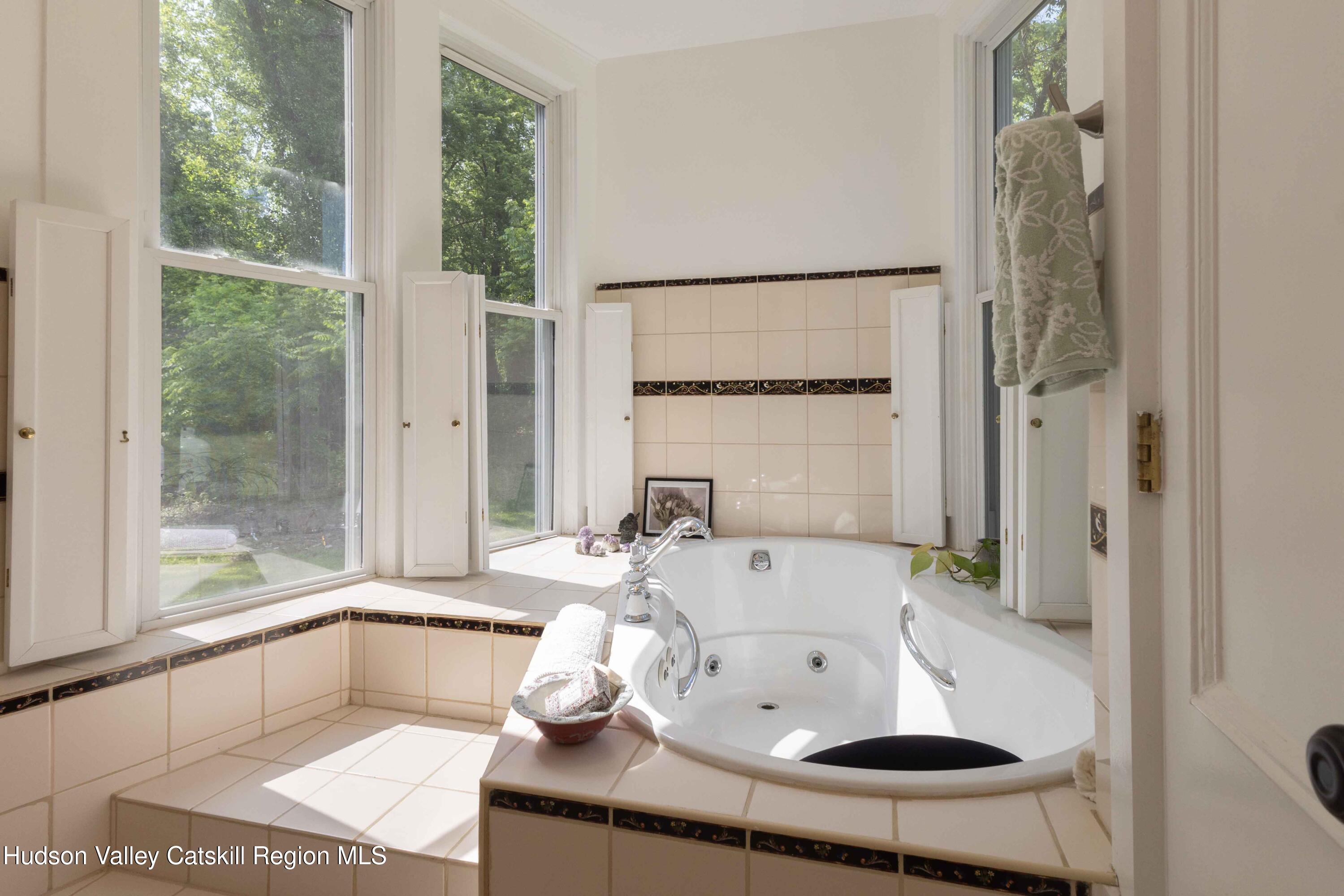 472 Lefever Falls Road Rosendale, NY 12401 - Photo 18 of 50 a white bath tub sitting next to a window