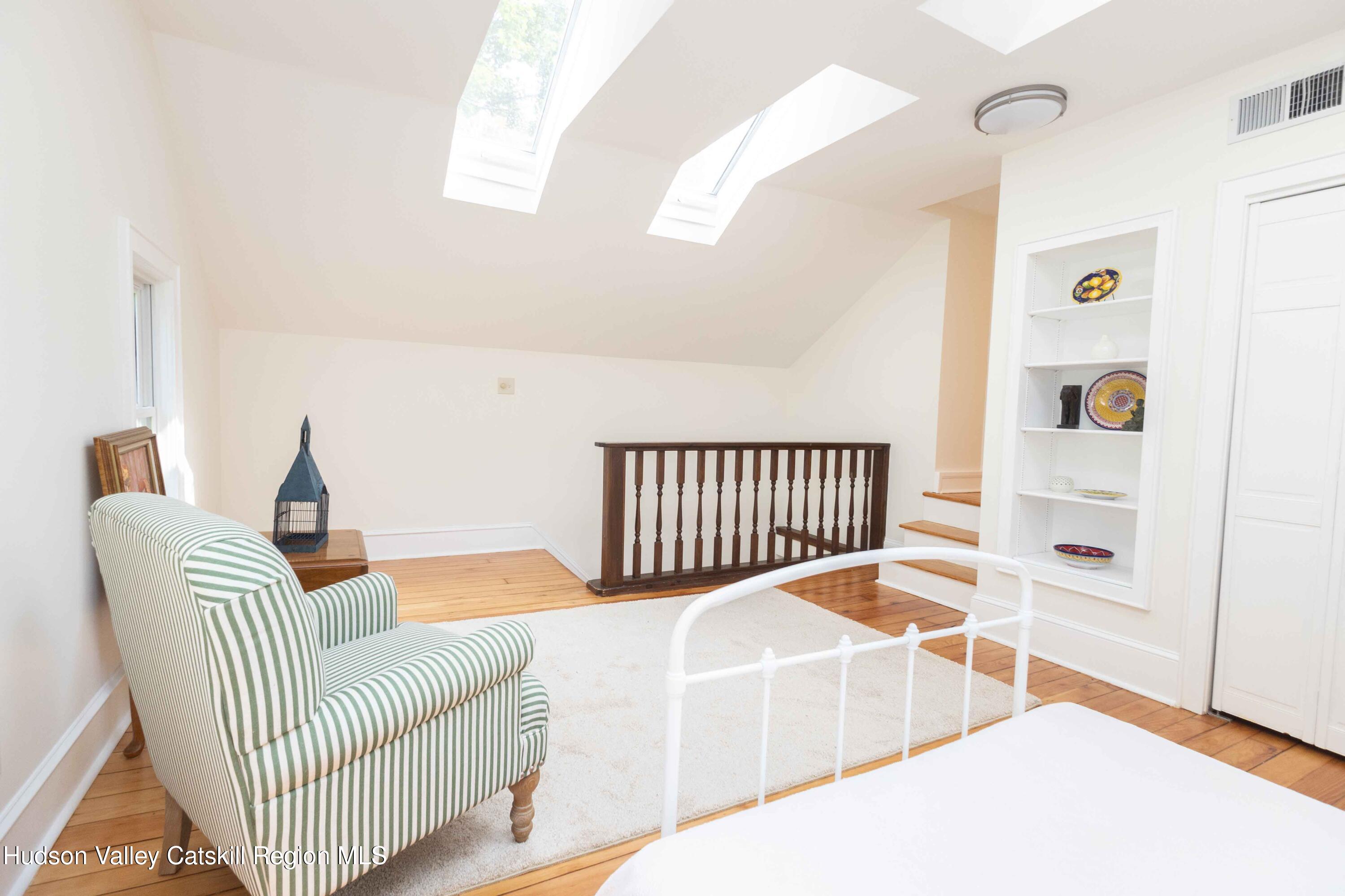472 Lefever Falls Road Rosendale, NY 12401 - Photo 30 of 50 a living room with a white bed and a chair