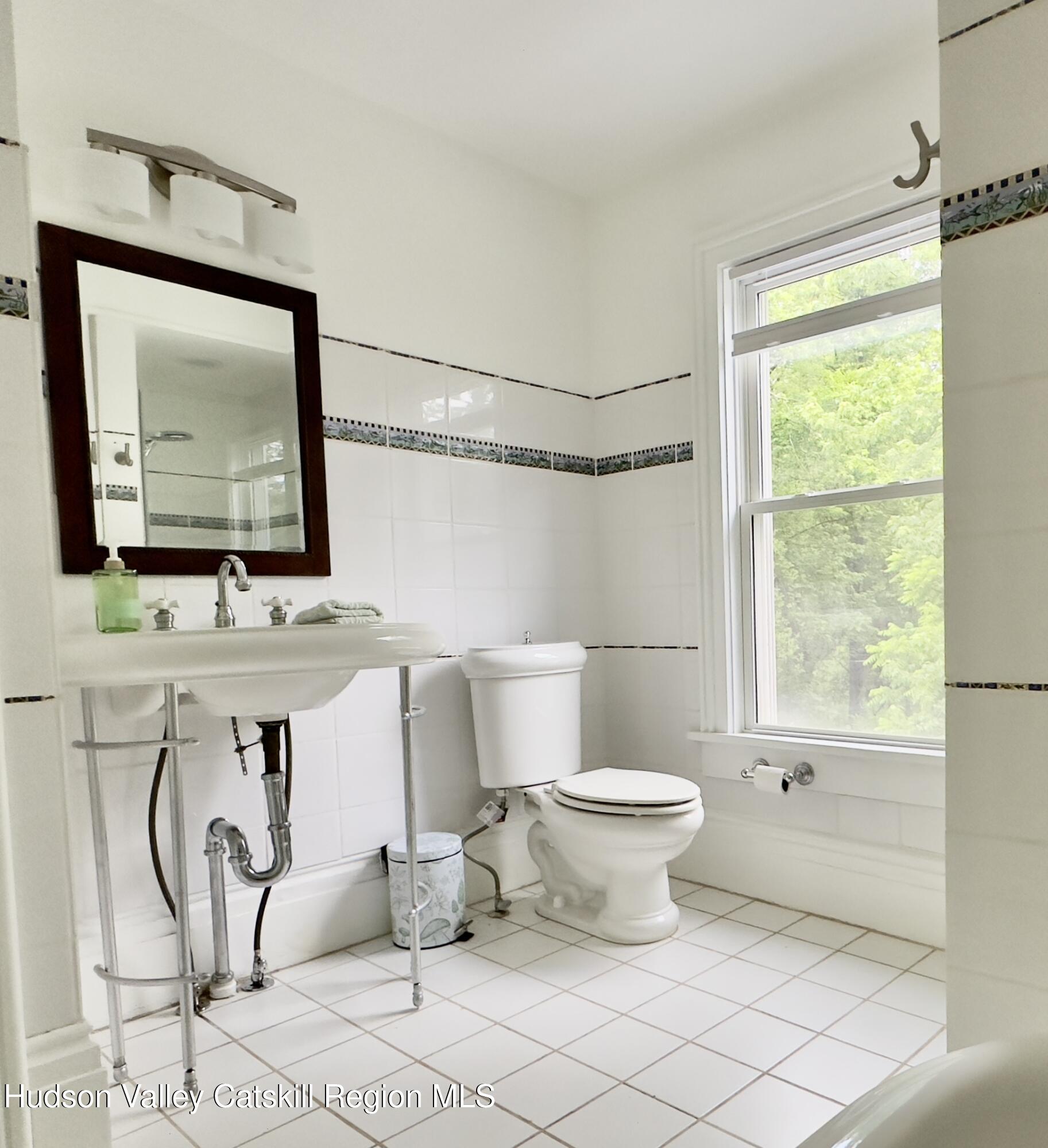 472 Lefever Falls Road Rosendale, NY 12401 - Photo 33 of 50 a bathroom with a toilet sink and mirror
