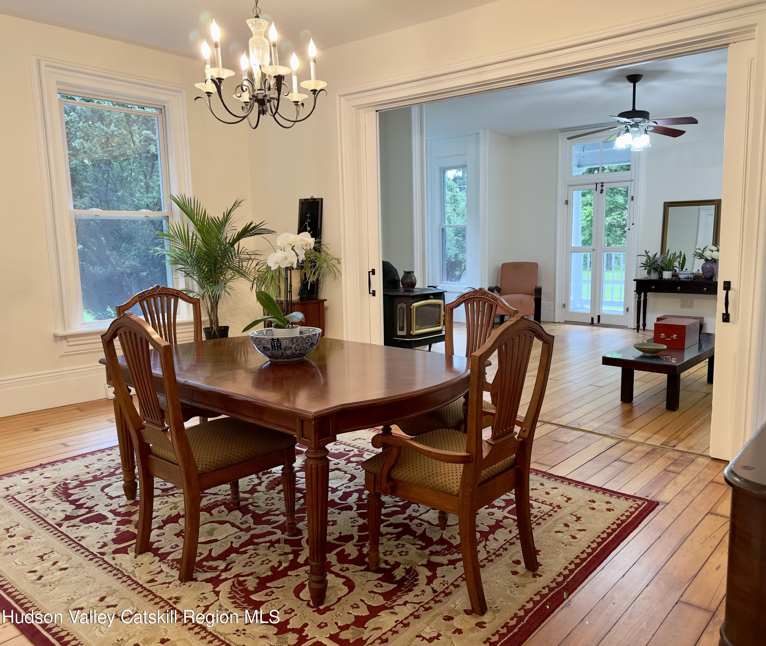 472 Lefever Falls Road Rosendale, NY 12401 - Photo 8 of 50 a dining room with furniture a chandelier and wooden floor