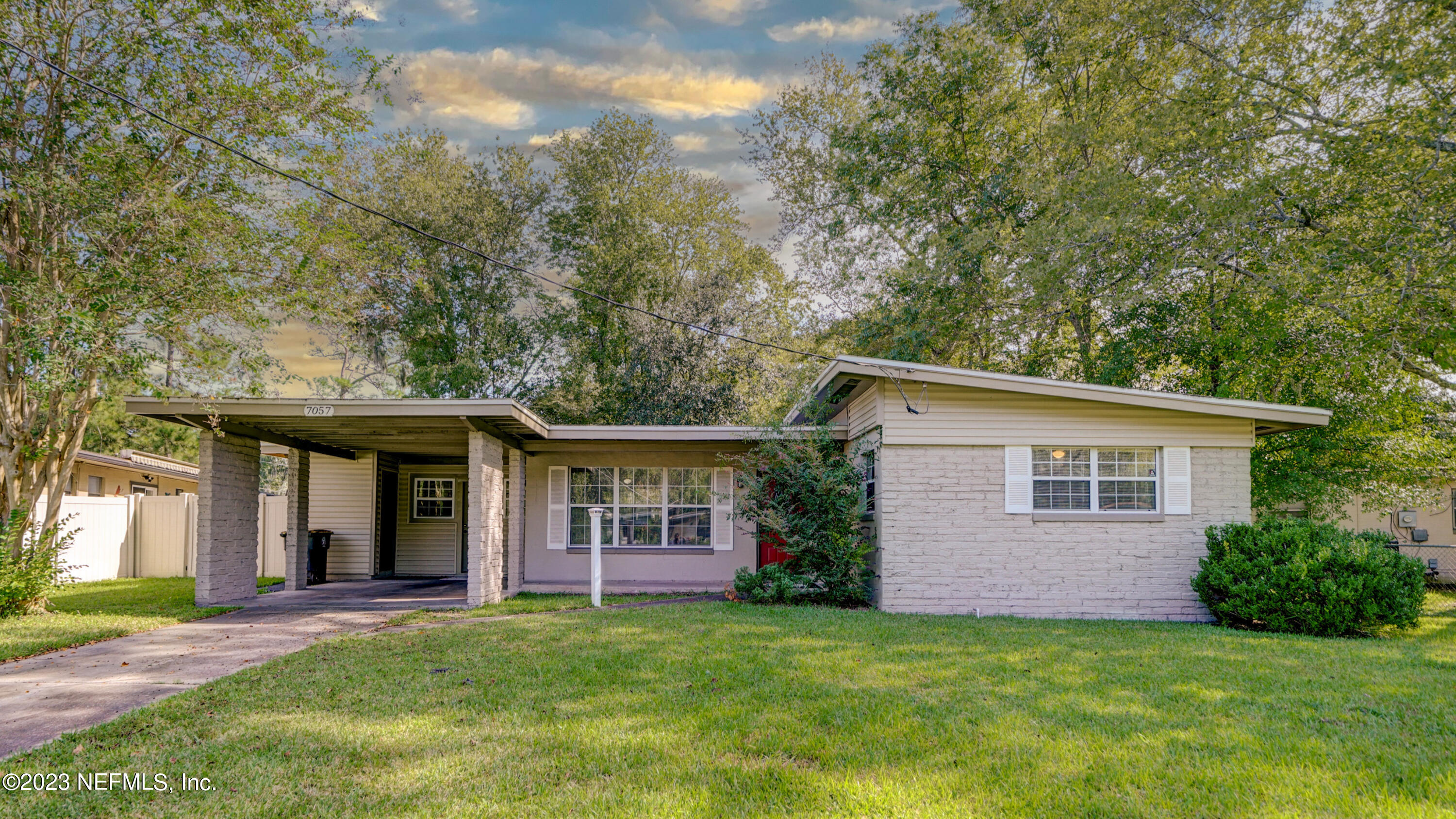 7057 Rollo Road Jacksonville, FL 32205 - Photo 1 of 30 front view of a house with a yard