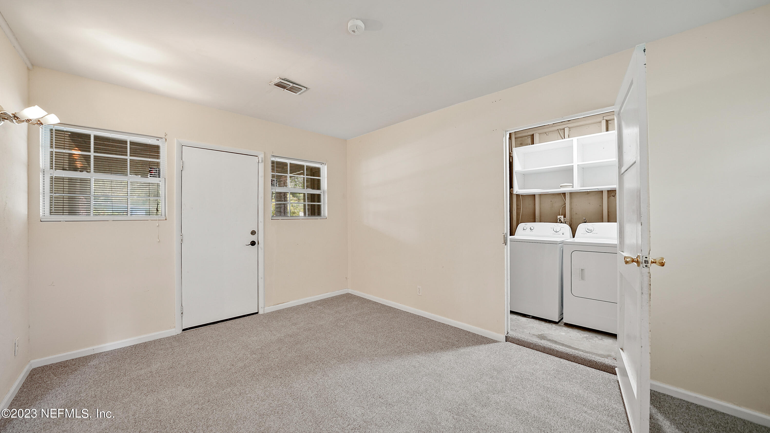 7057 Rollo Road Jacksonville, FL 32205 - Photo 13 of 30 an empty room with windows