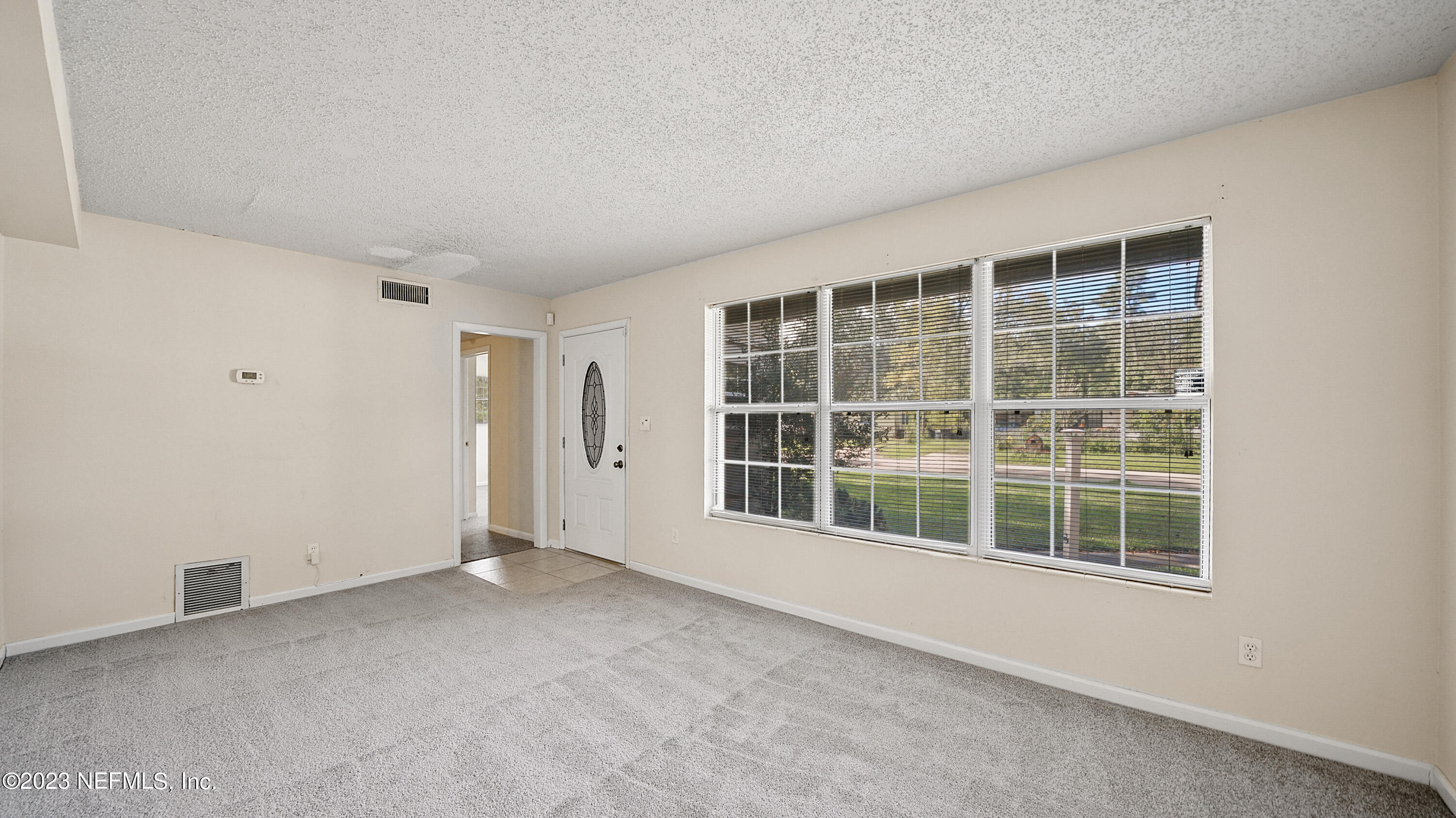 7057 Rollo Road Jacksonville, FL 32205 - Photo 2 of 30 an empty room with windows