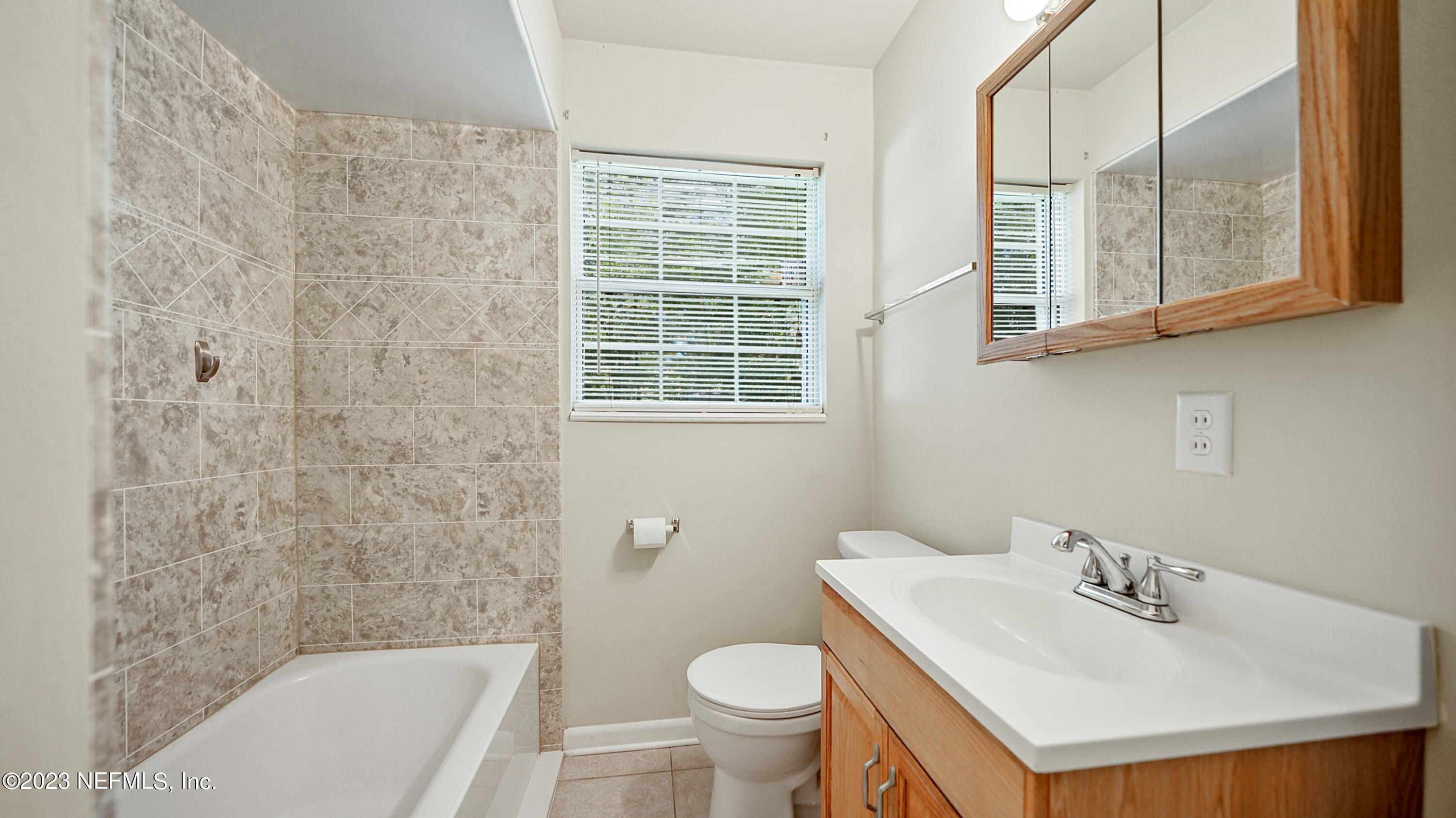 7057 Rollo Road Jacksonville, FL 32205 - Photo 21 of 30 a bathroom with a sink toilet and shower