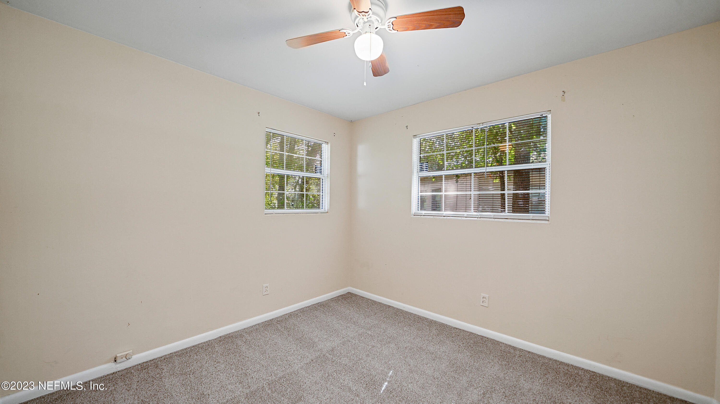7057 Rollo Road Jacksonville, FL 32205 - Photo 23 of 30 an empty room with a window