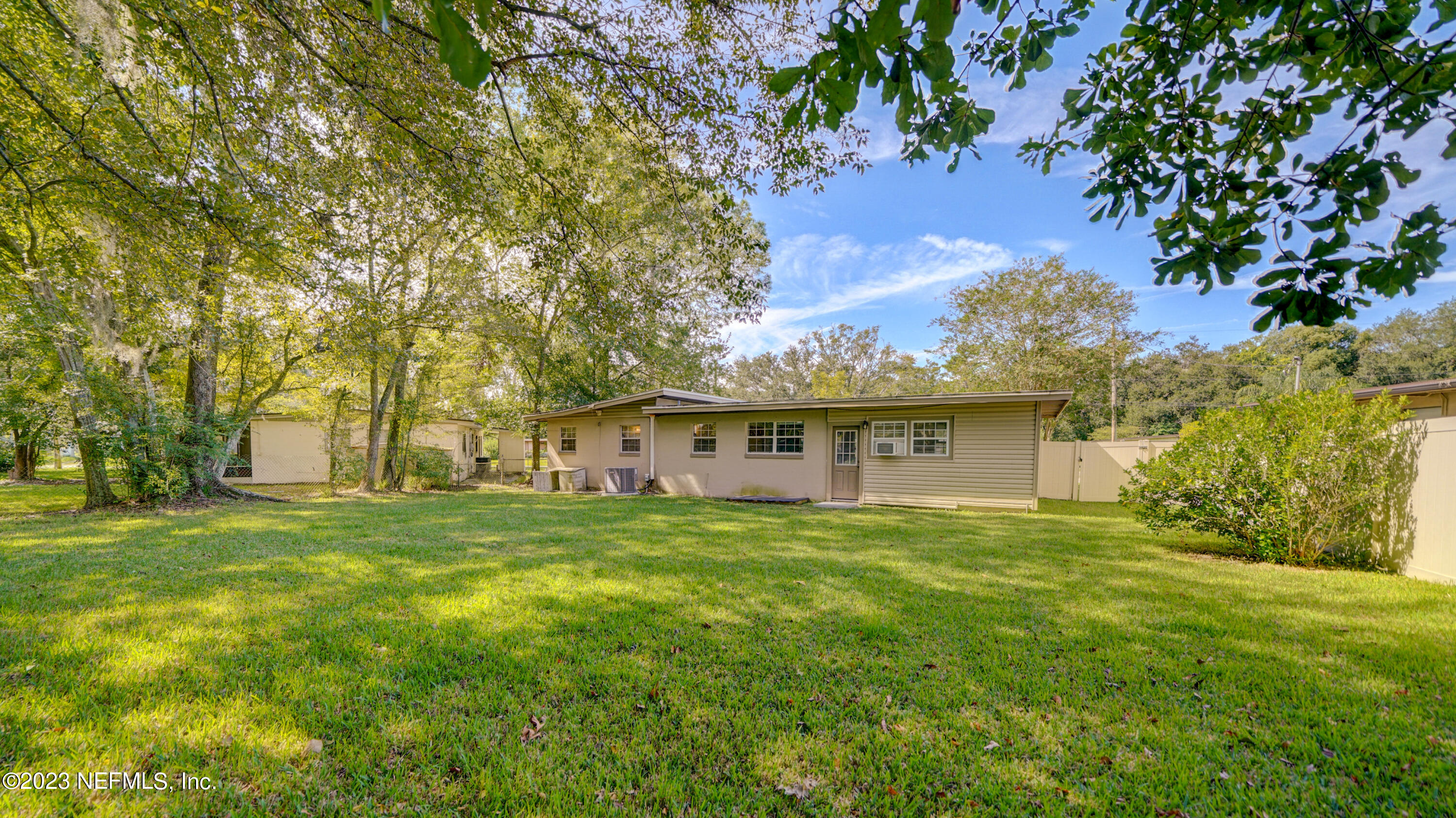 7057 Rollo Road Jacksonville, FL 32205 - Photo 26 of 30 a front view of house with yard and green space