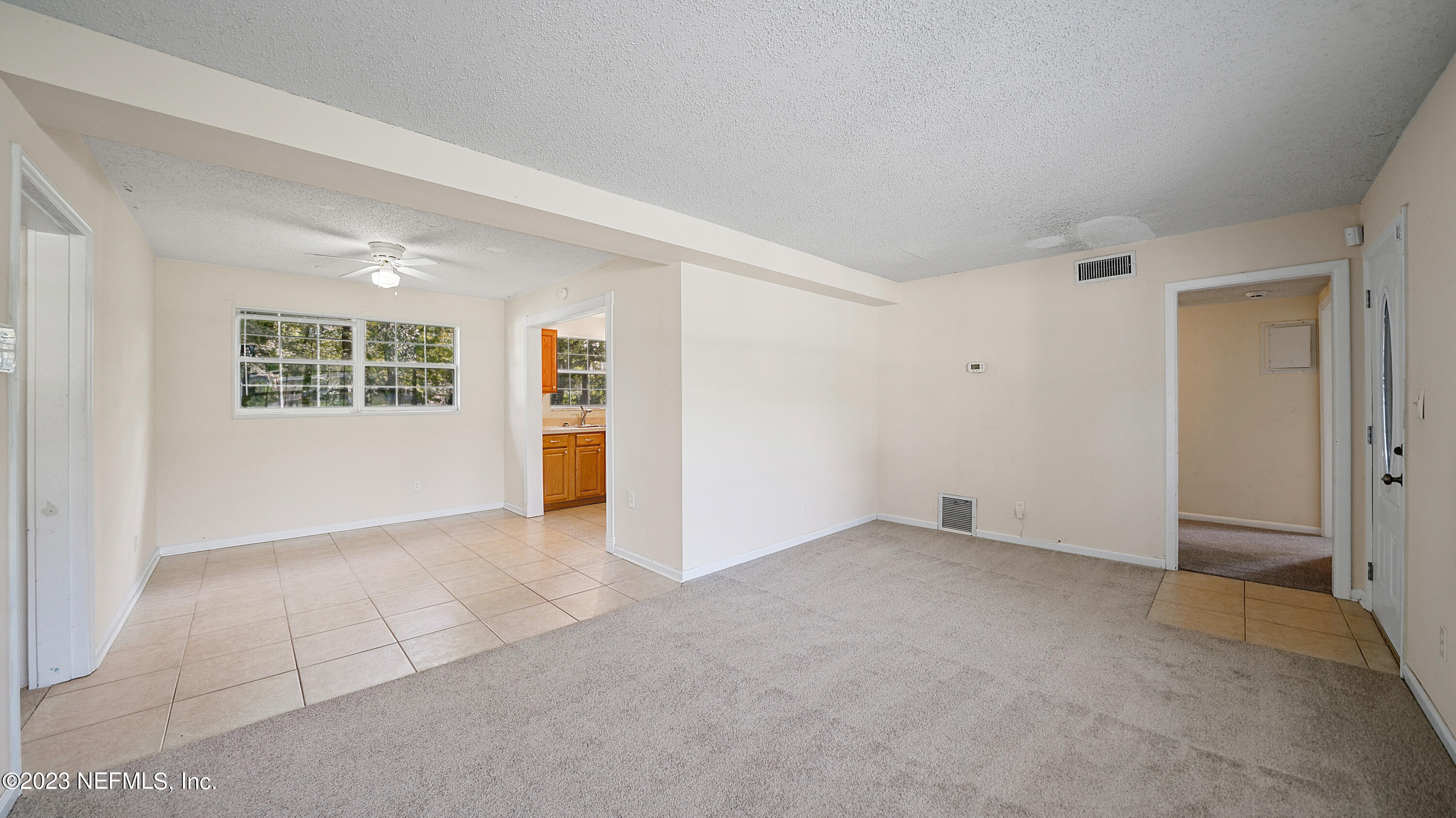 7057 Rollo Road Jacksonville, FL 32205 - Photo 3 of 30 an empty room with windows