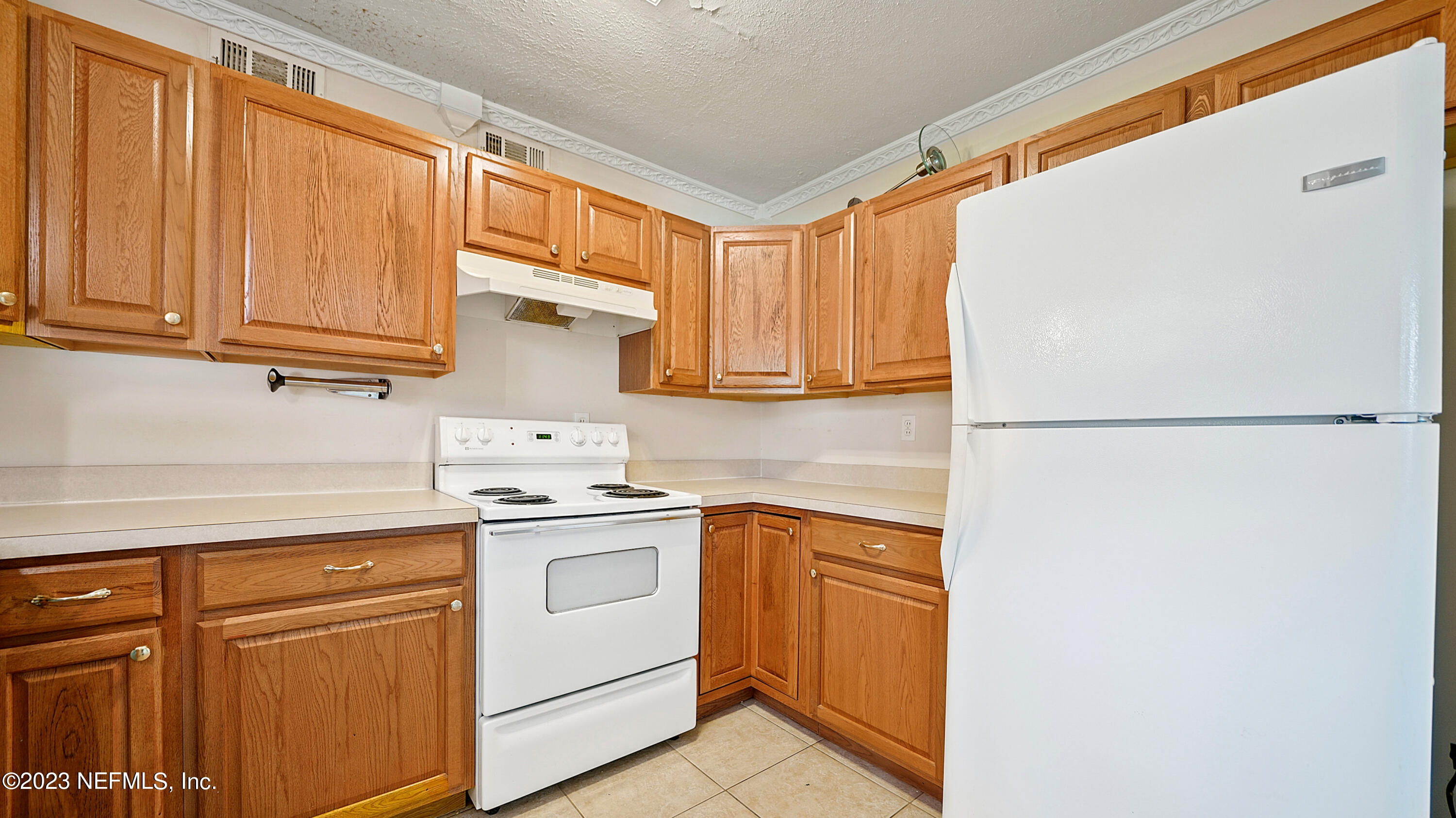 7057 Rollo Road Jacksonville, FL 32205 - Photo 8 of 30 a kitchen with stainless steel appliances granite countertop a refrigerator sink and cabinets