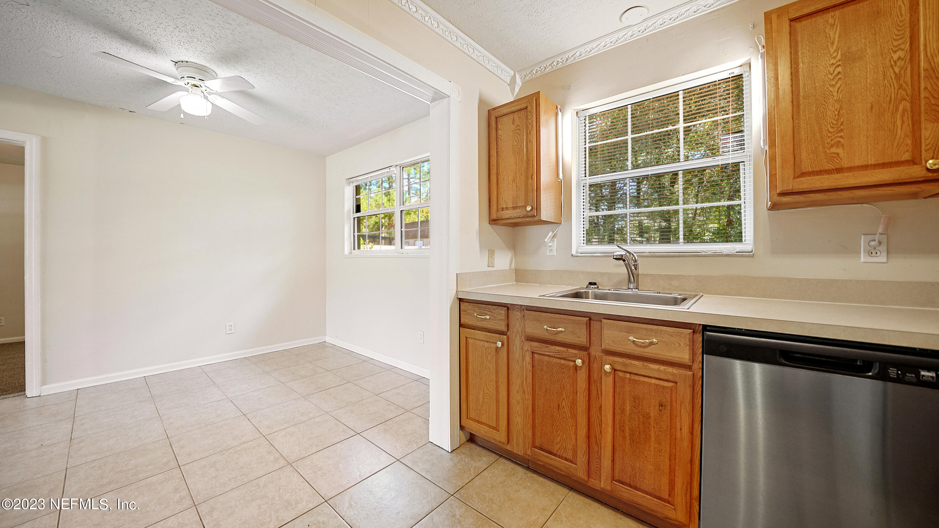 7057 Rollo Road Jacksonville, FL 32205 - Photo 9 of 30 a kitchen with a sink cabinets and window