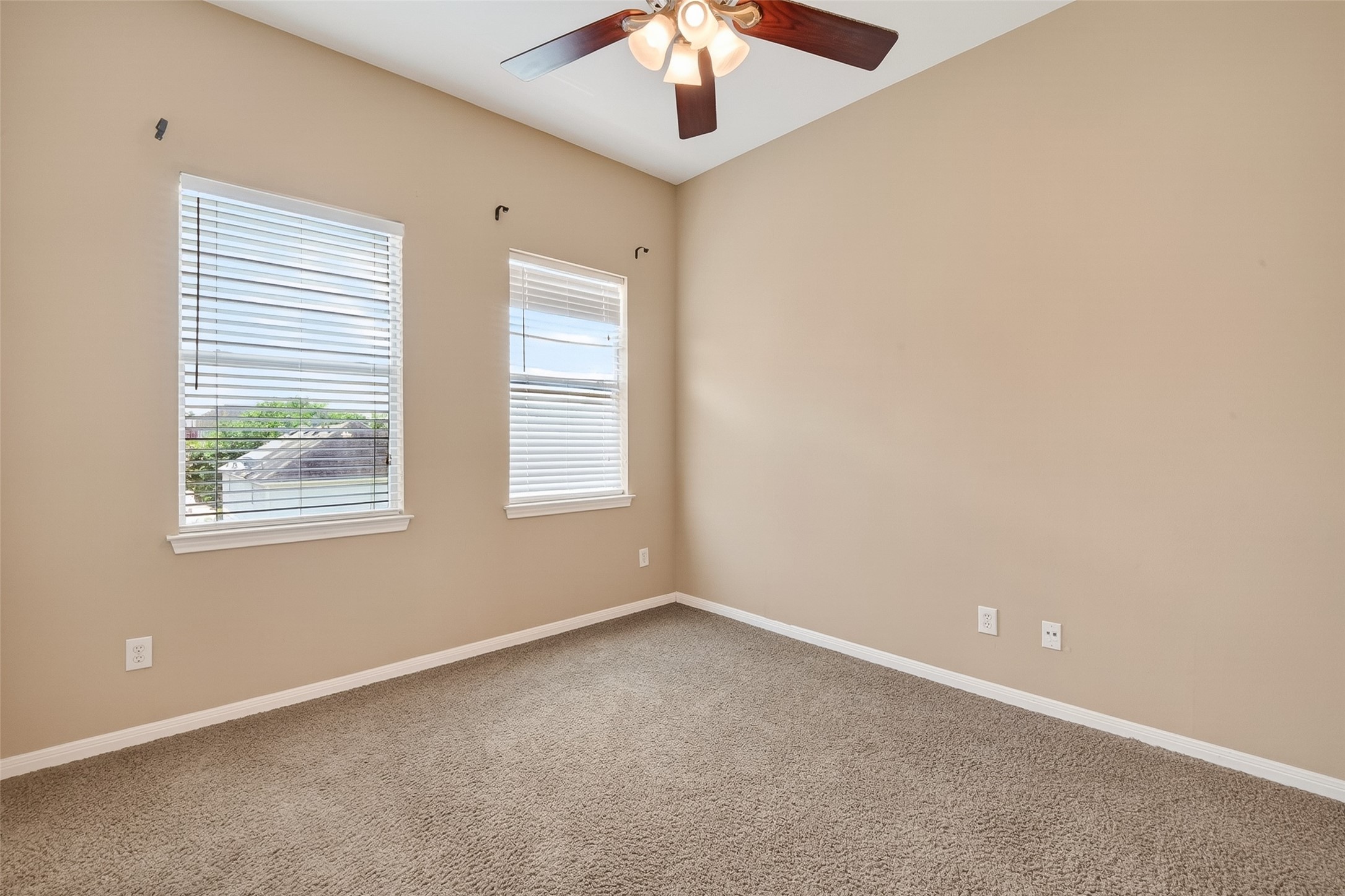 2804 Chenevert Street Houston, TX 77004 - Photo 23 of 37 an empty room with a chandelier fan and windows