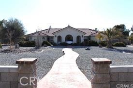 20765 Tonawanda Road Apple Valley, CA 92307 - Photo 1 of 1 a front view of a house with a yard
