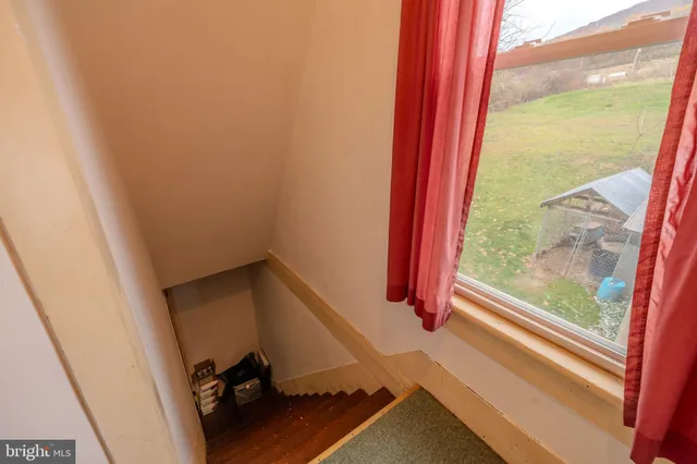 a view of a hallway to a livingroom and a couch