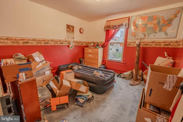 a bedroom with a bed and a mirror