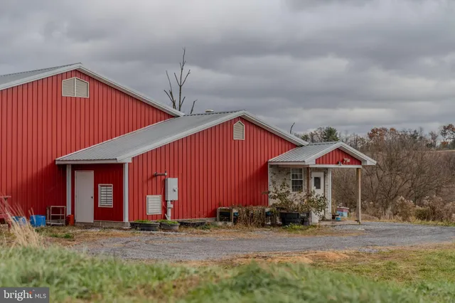 an aerial view of a house with garden space and street view