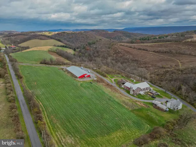 an aerial view of house with yard swimming pool and outdoor seating