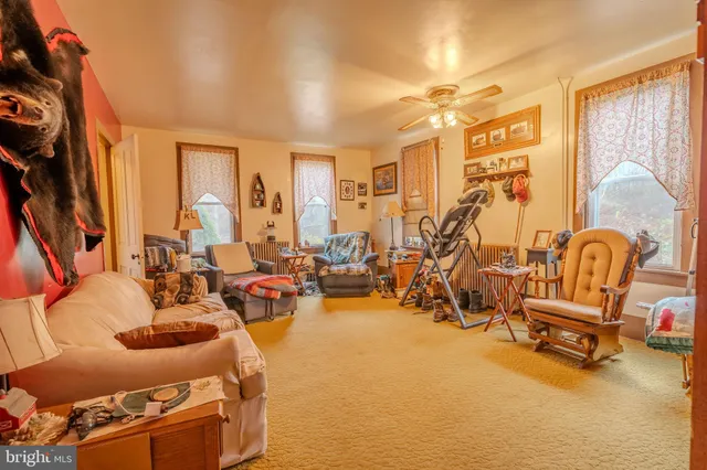 a view of a livingroom with furniture and a window