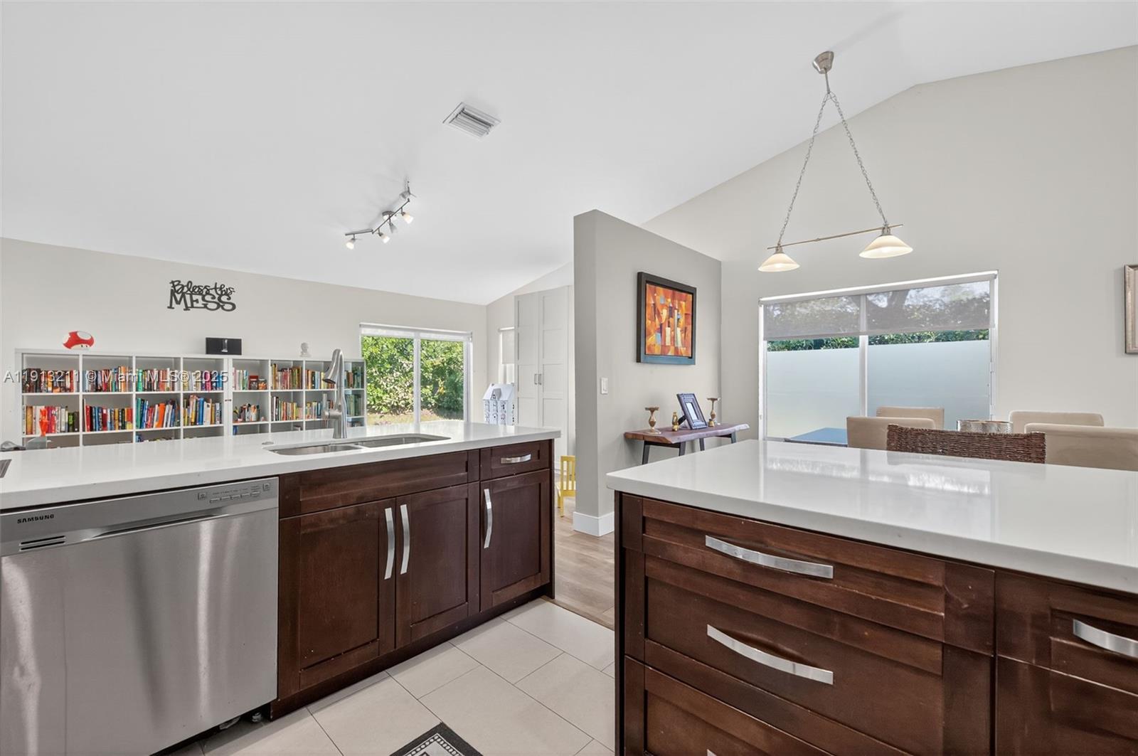 4357 Magnolia Ridge Drive Weston, FL 33331 - Photo 13 of 54 a kitchen with kitchen island granite countertop a sink and dishwasher with wooden floor
