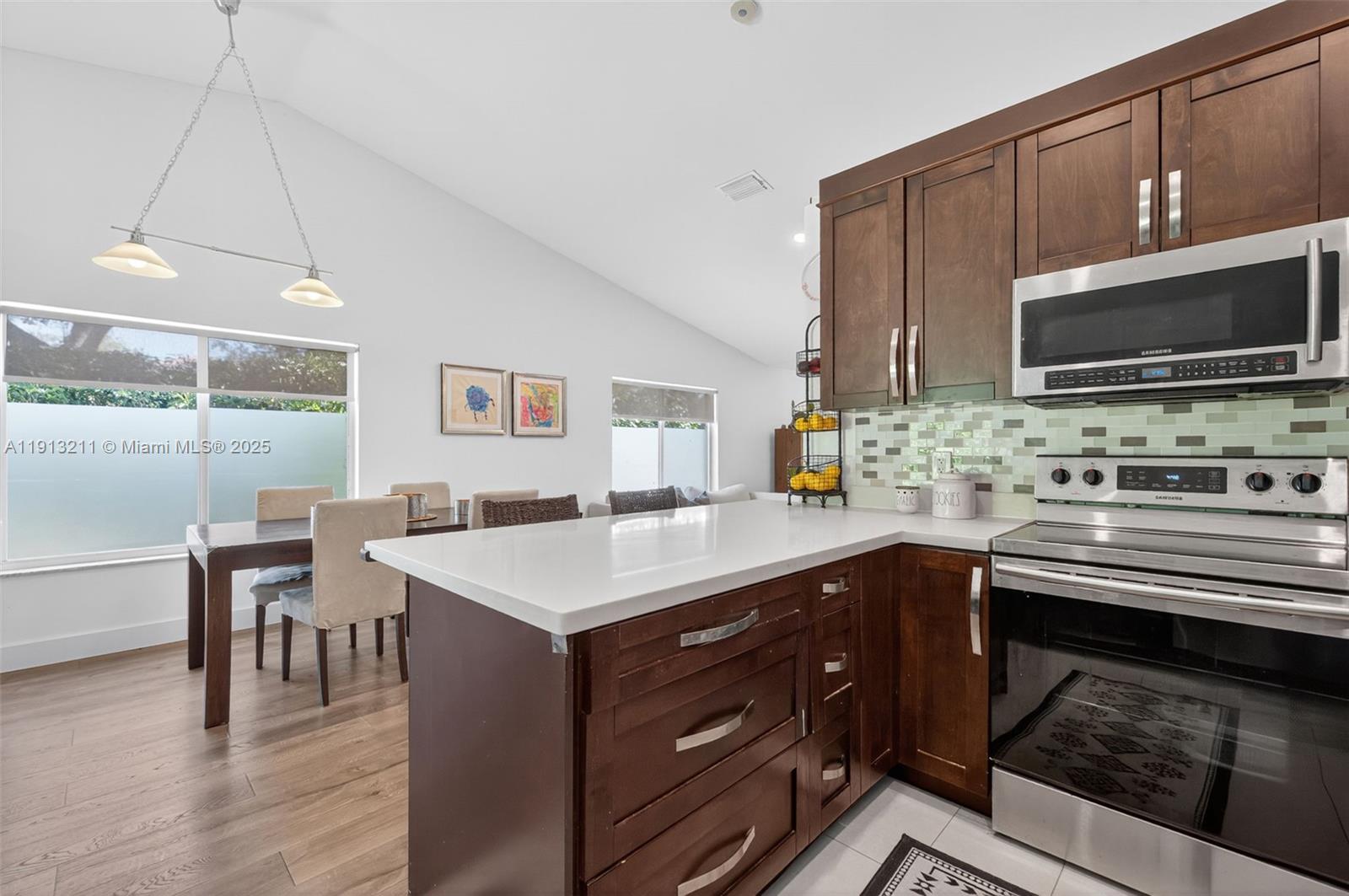 4357 Magnolia Ridge Drive Weston, FL 33331 - Photo 14 of 54 a kitchen with a sink cabinets and wooden floor