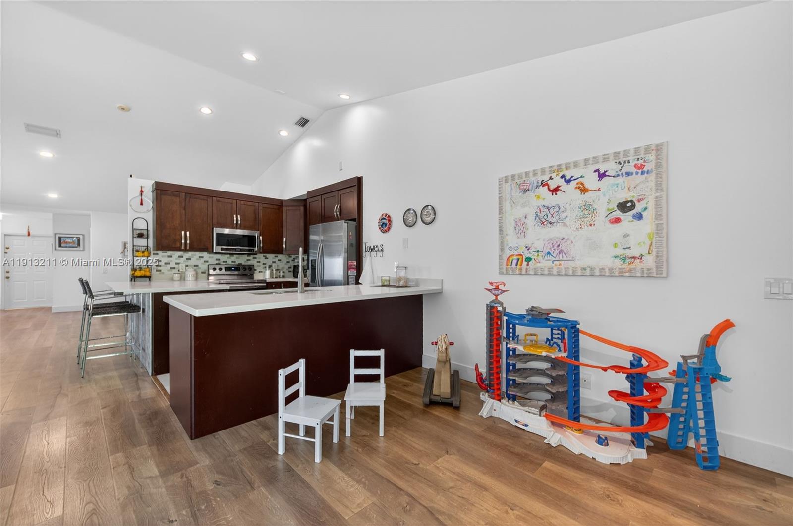 4357 Magnolia Ridge Drive Weston, FL 33331 - Photo 16 of 54 a kitchen with stainless steel appliances granite countertop a refrigerator and a wooden cabinets