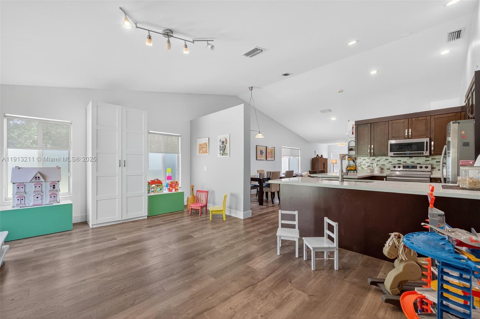 4357 Magnolia Ridge Drive Weston, FL 33331 - Photo 17 of 54 a living room with stainless steel appliances furniture and wooden floor