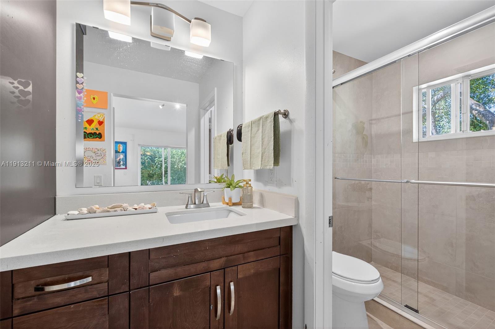 4357 Magnolia Ridge Drive Weston, FL 33331 - Photo 20 of 54 a bathroom with a sink a toilet and shower