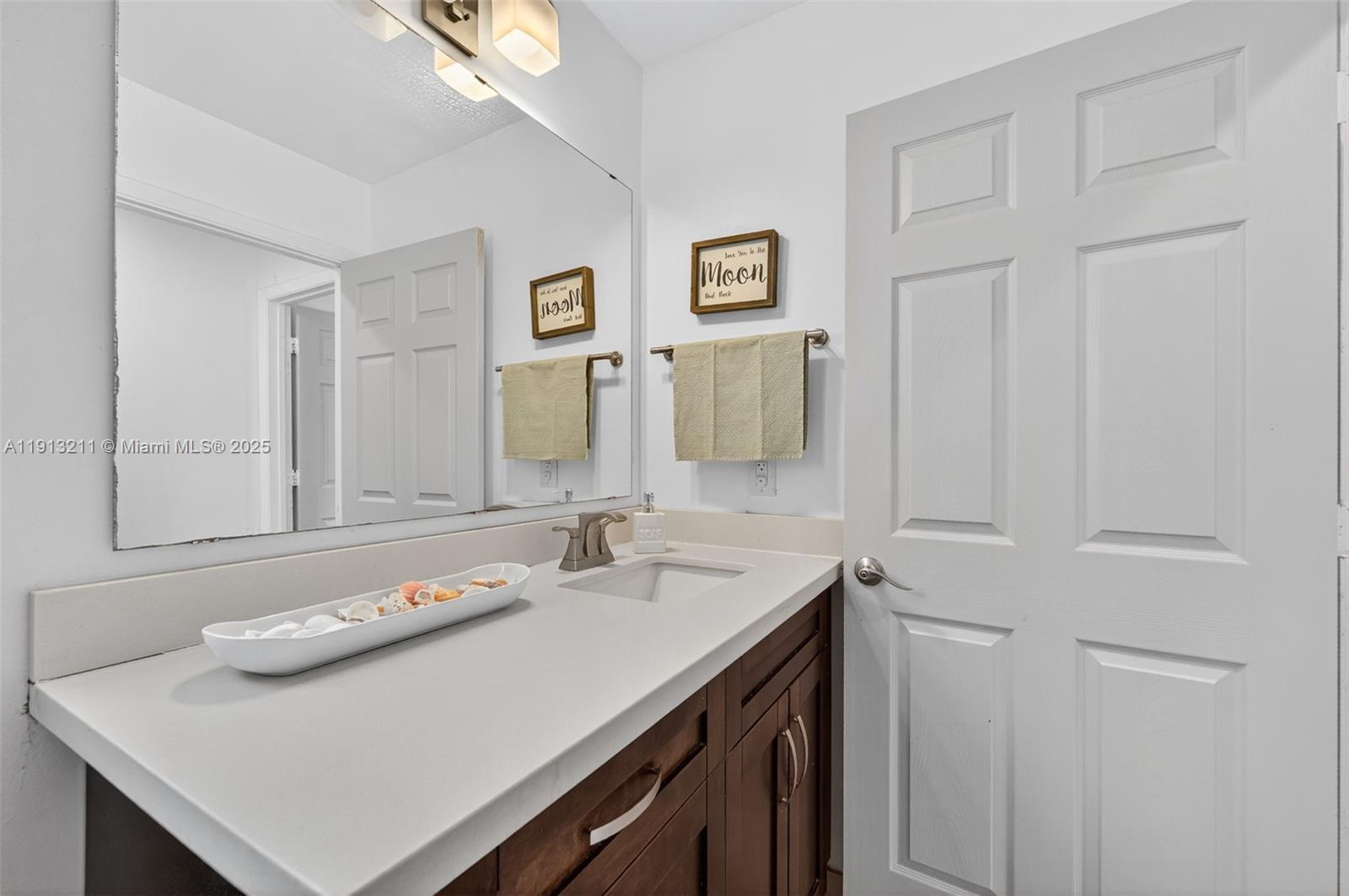 4357 Magnolia Ridge Drive Weston, FL 33331 - Photo 29 of 54 a bathroom with a sink and a mirror