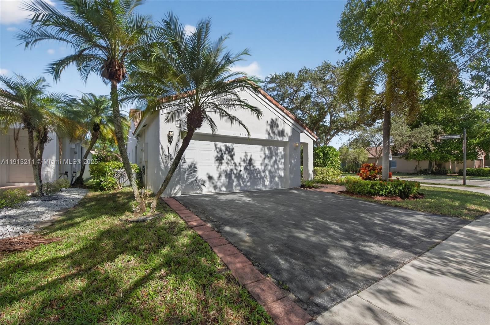 4357 Magnolia Ridge Drive Weston, FL 33331 - Photo 30 of 54 a view of a backyard of a house
