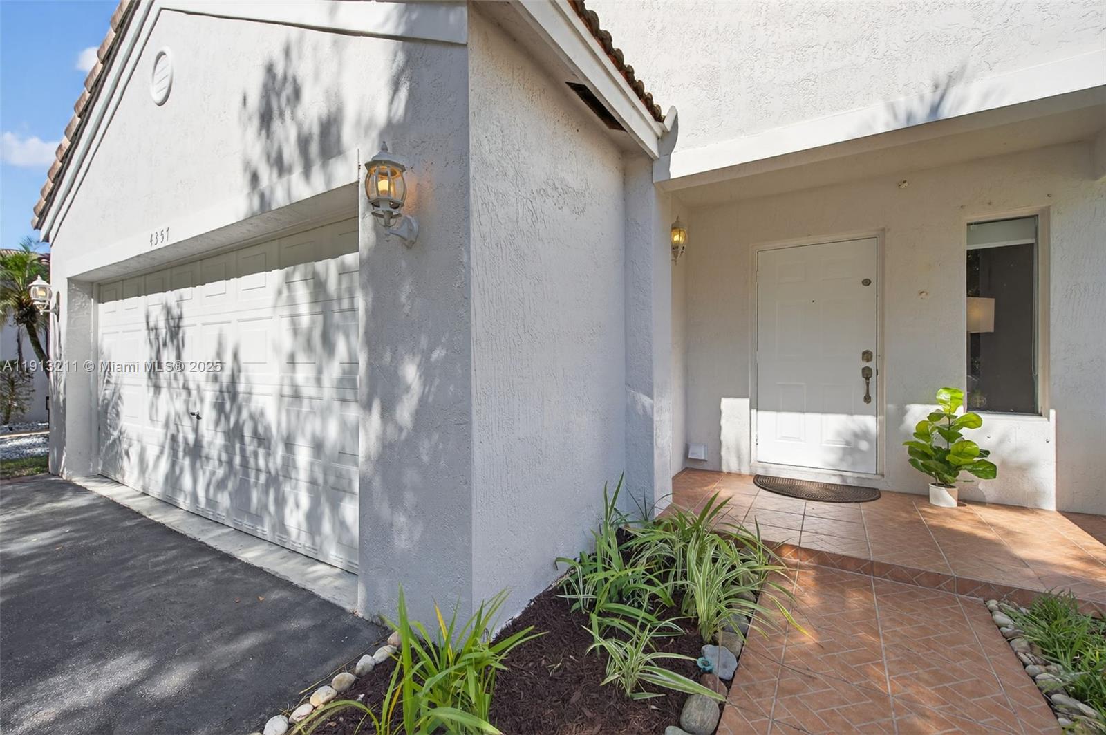 4357 Magnolia Ridge Drive Weston, FL 33331 - Photo 3 of 54 a front view of a house with outdoor seating
