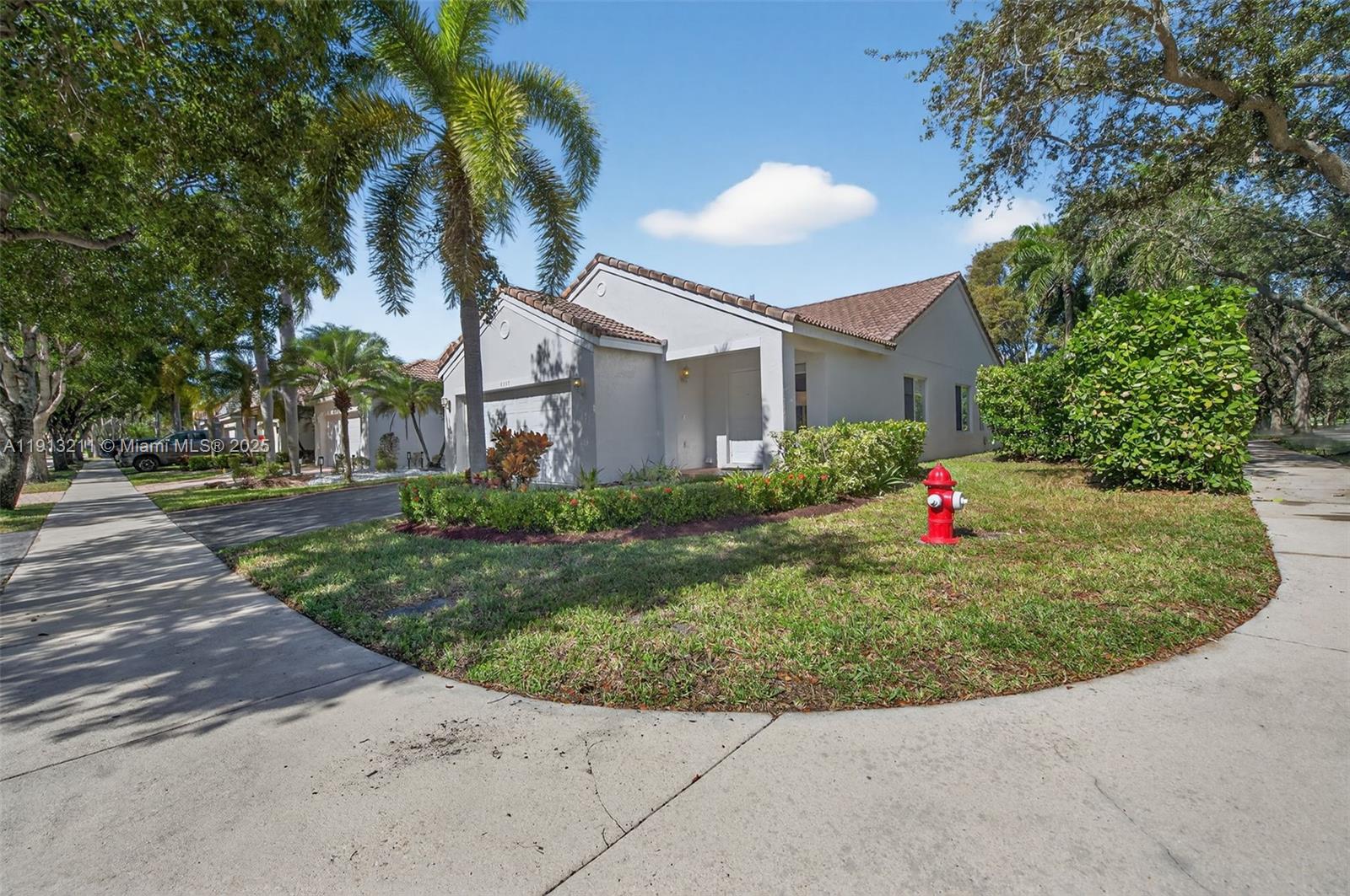 4357 Magnolia Ridge Drive Weston, FL 33331 - Photo 33 of 54 a front view of a house with a yard