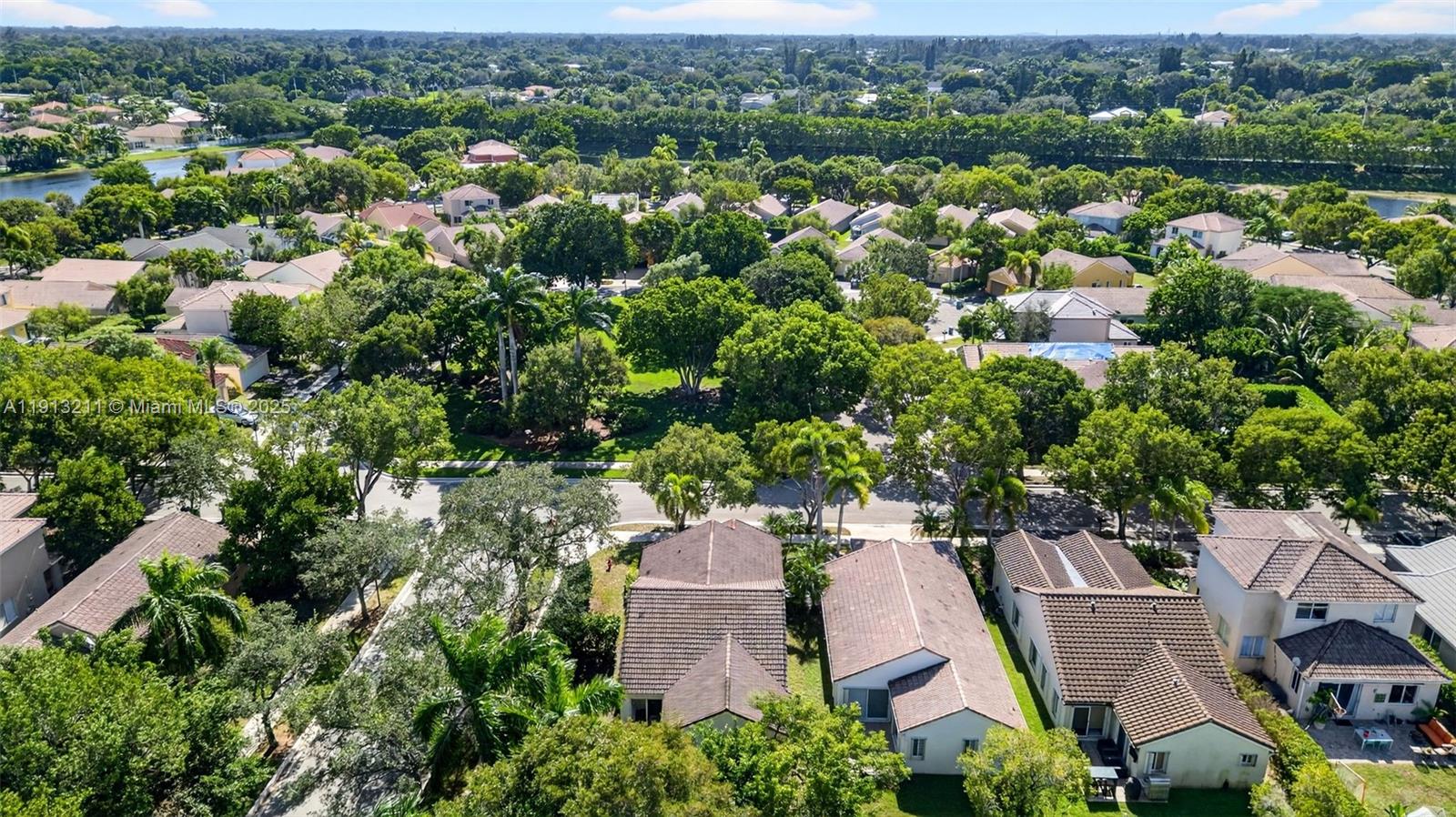 4357 Magnolia Ridge Drive Weston, FL 33331 - Photo 38 of 54 an aerial view of residential houses with outdoor space and trees
