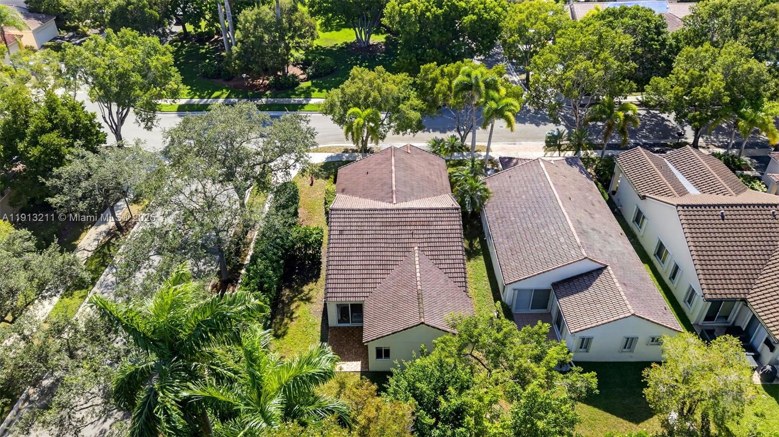 4357 Magnolia Ridge Drive Weston, FL 33331 - Photo 39 of 54 an aerial view of a house with a yard and large trees