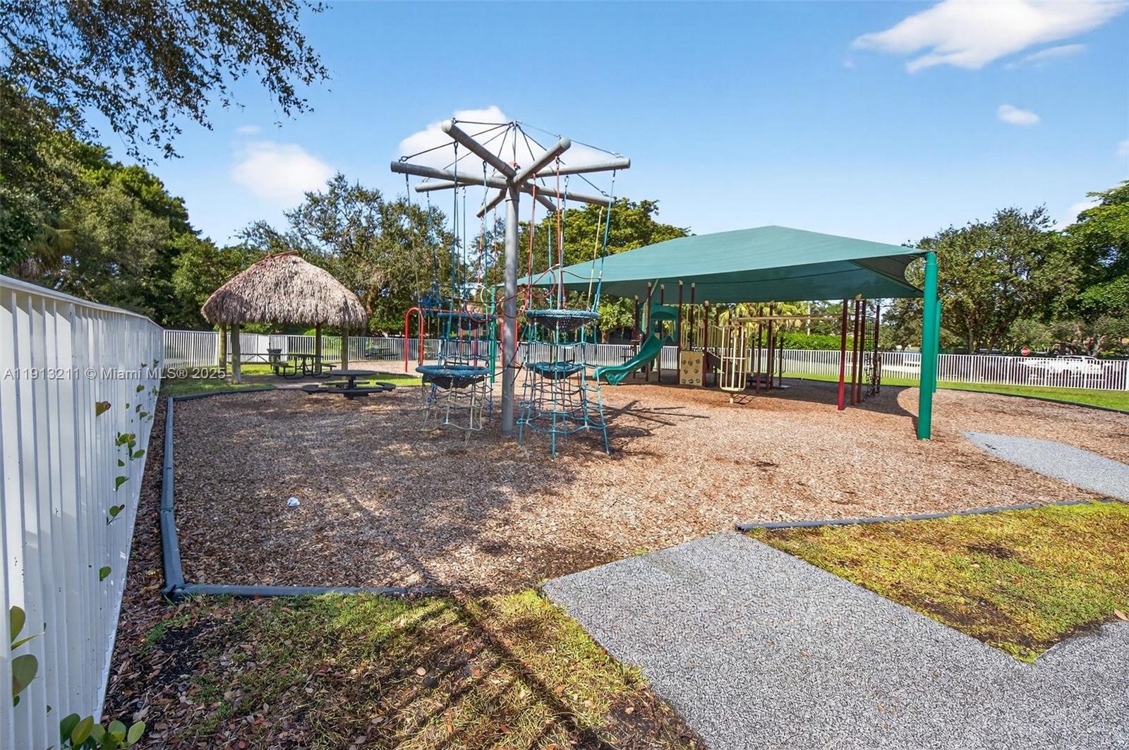 4357 Magnolia Ridge Drive Weston, FL 33331 - Photo 48 of 54 a backyard of a house with barbeque oven table and chairs