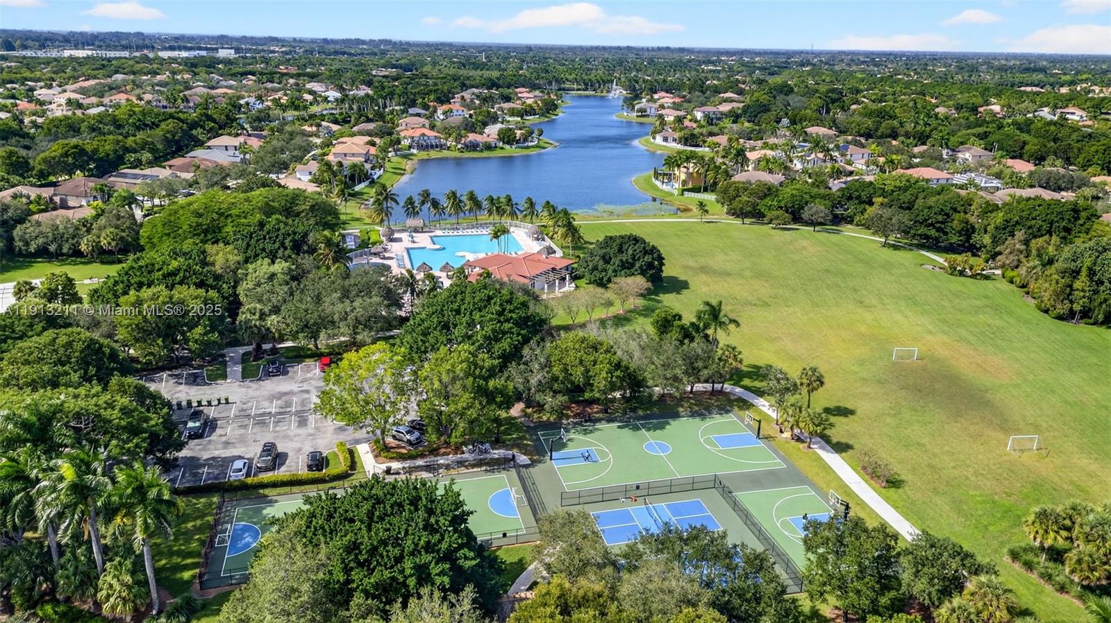 4357 Magnolia Ridge Drive Weston, FL 33331 - Photo 50 of 54 an aerial view of residential houses with outdoor space and trees