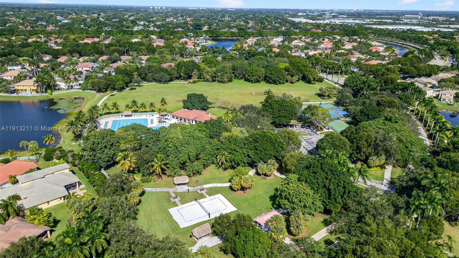 4357 Magnolia Ridge Drive Weston, FL 33331 - Photo 51 of 54 an aerial view of residential houses with outdoor space and trees