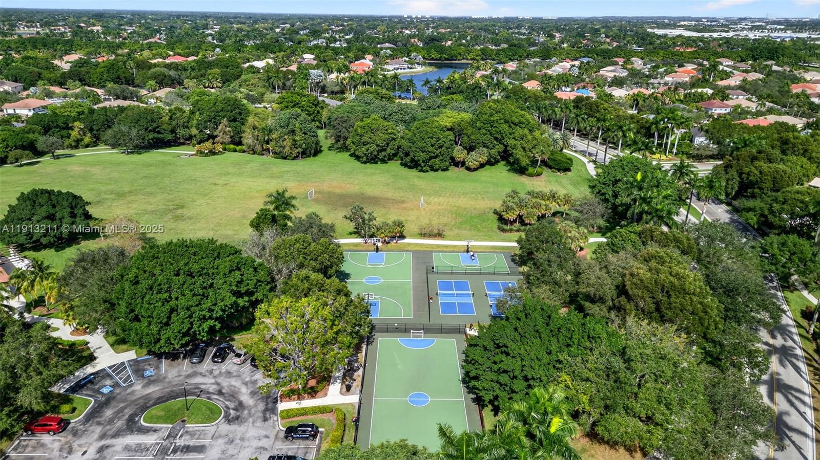 4357 Magnolia Ridge Drive Weston, FL 33331 - Photo 52 of 54 an aerial view of residential houses with outdoor space and trees