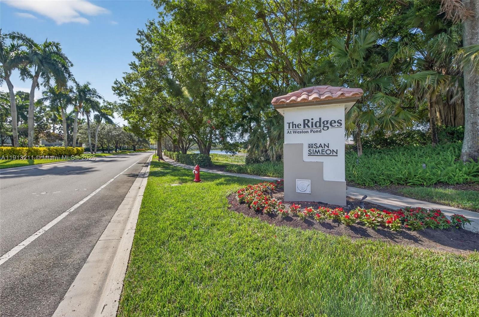 4357 Magnolia Ridge Drive Weston, FL 33331 - Photo 54 of 54 a front view of a house with a yard