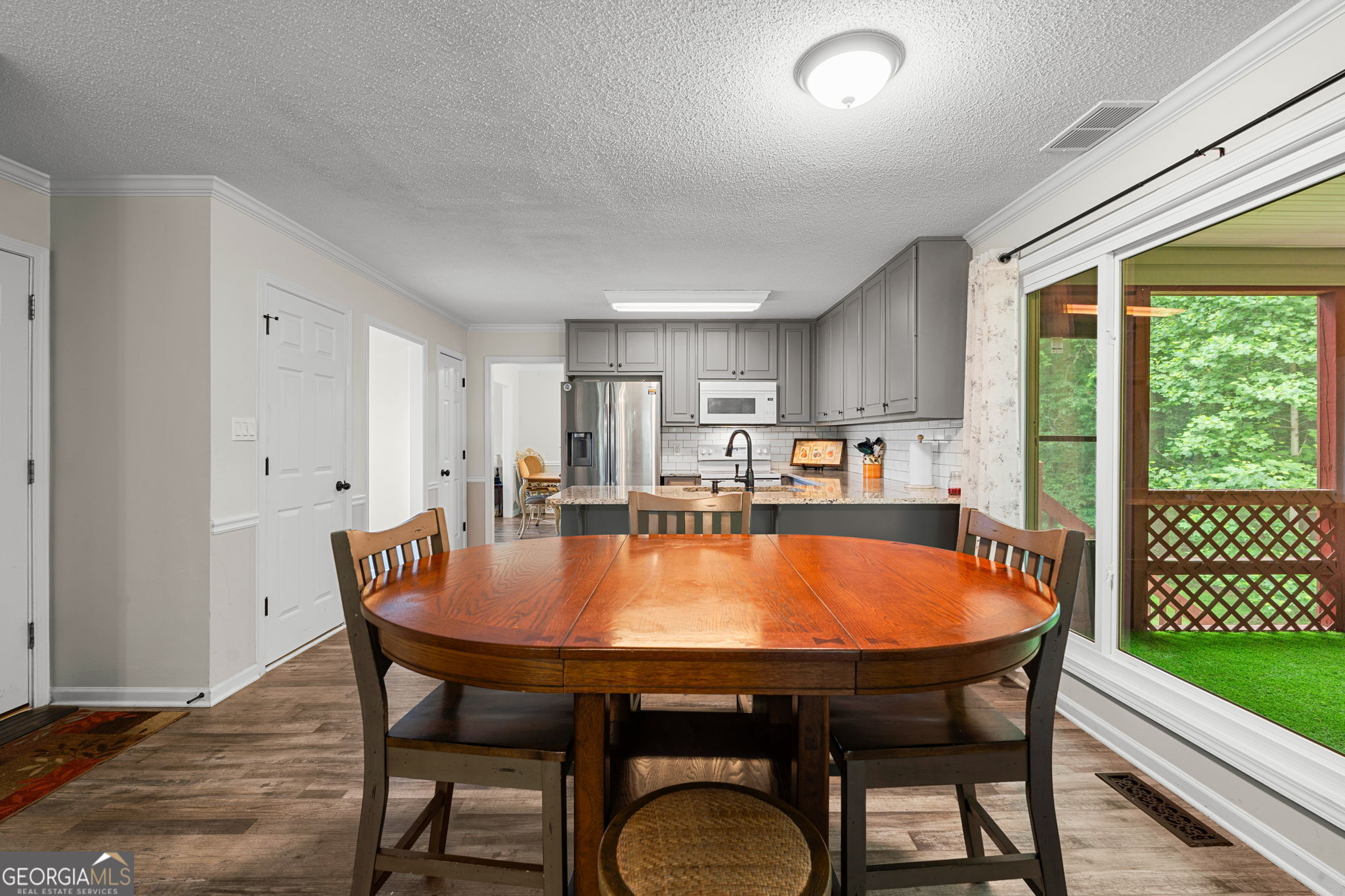 375 Gaelic Way Tyrone, GA 30290 - Photo 15 of 54 a dining room with furniture window and wooden floor
