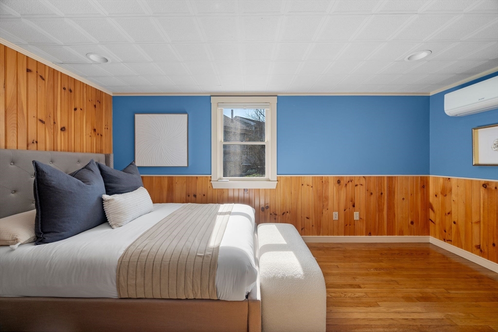 154 R Eastern Avenue Essex, MA 01929 - Photo 15 of 40 a bedroom with a large bed and wooden floor